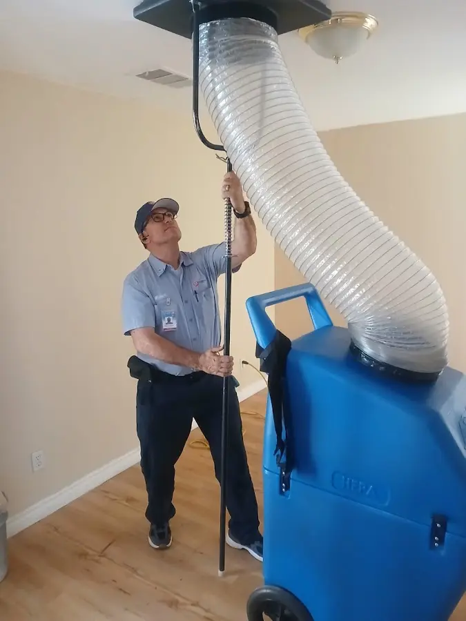 Furnace Tune-Up technician using HEPA equipment in Leawood